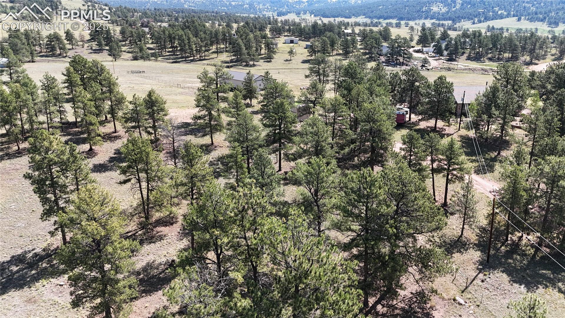 Aerial view of sparsely populated area featuring a tree filled landscape