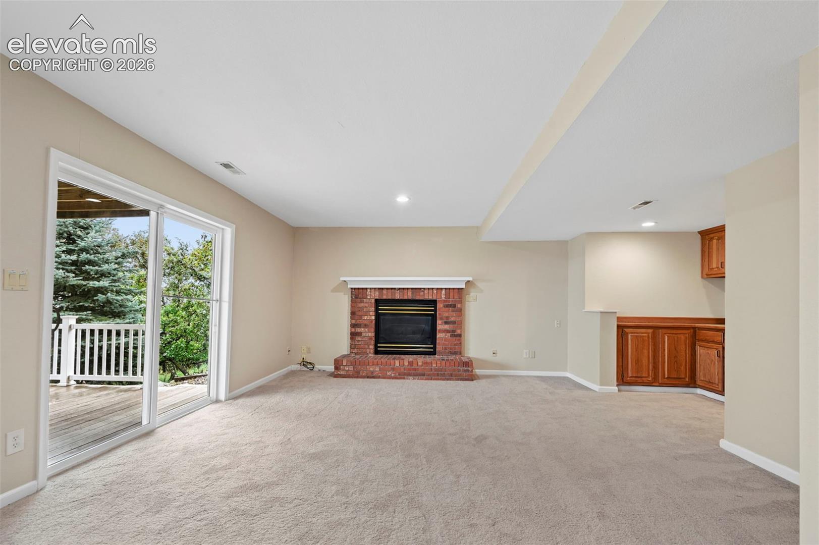 Large walkout basement with brick fireplace to walkout to lower deck 