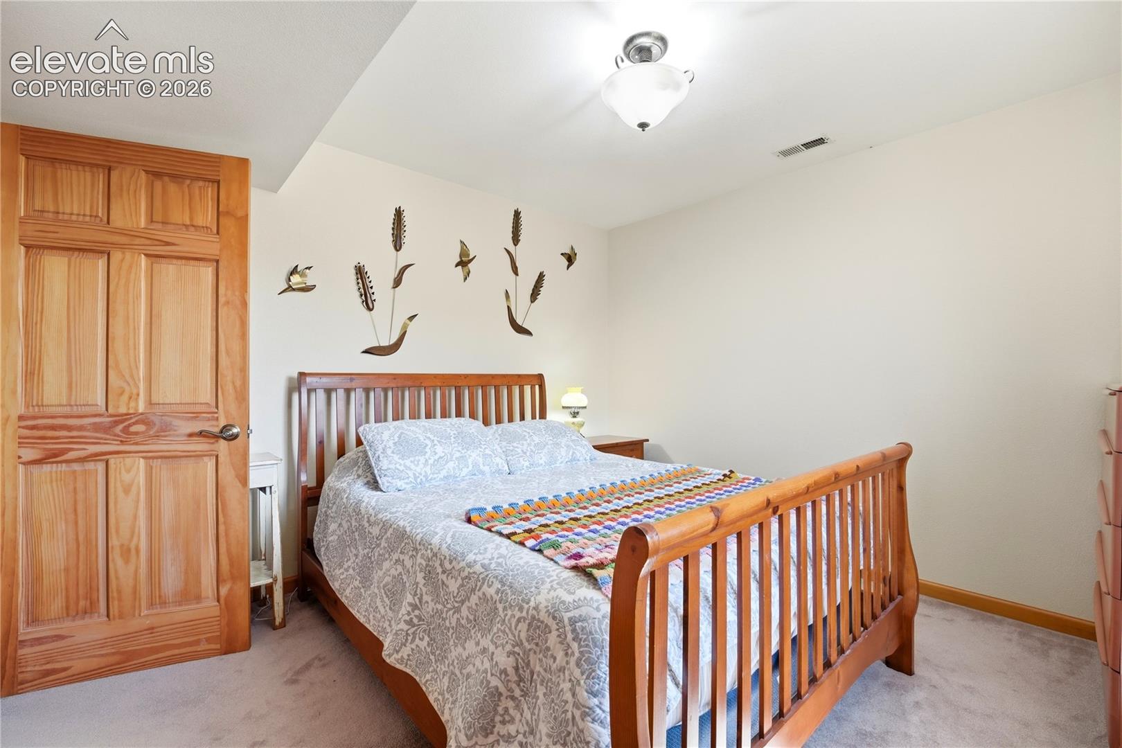 Carpeted flooring with light-colored walls and a semi-flush mount ceiling light