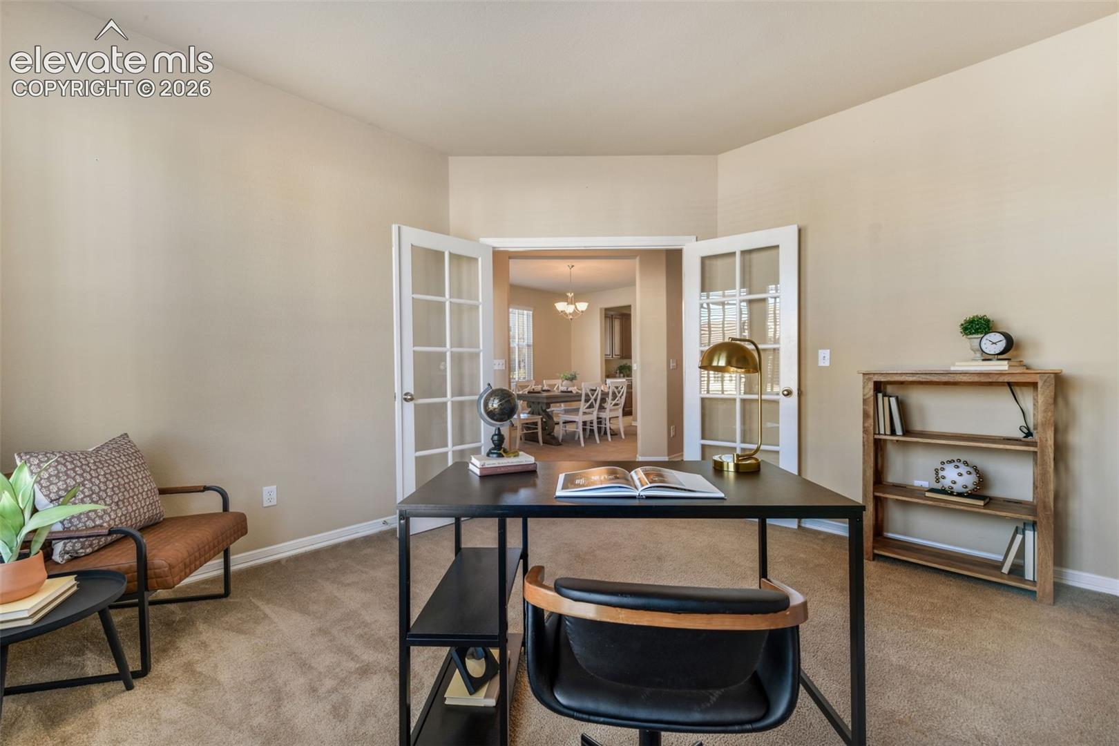 Carpeted room with a vaulted ceiling