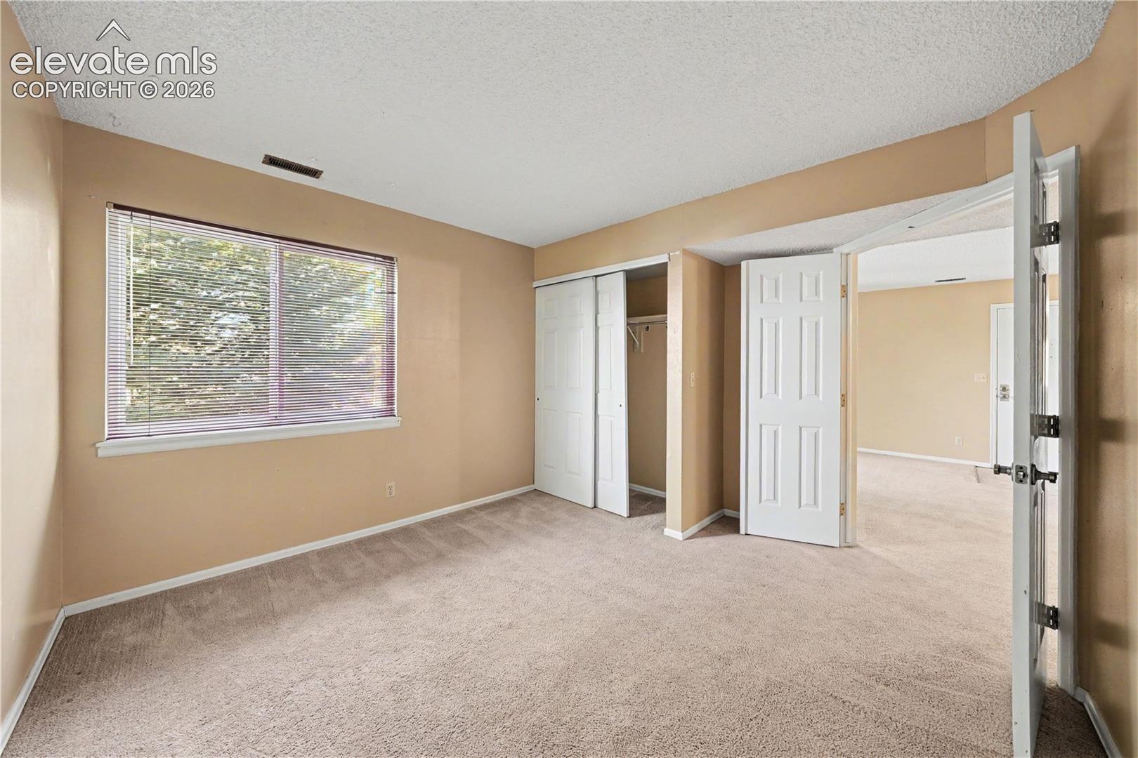 Bedroom with natural light and carpeted floors