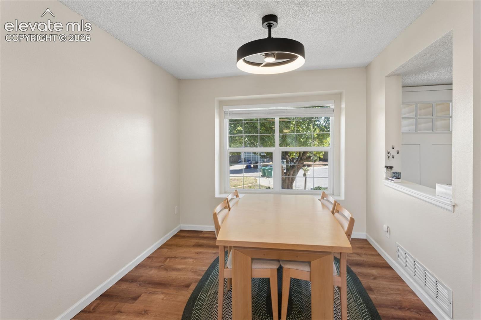Recessed dining space featuring a large window