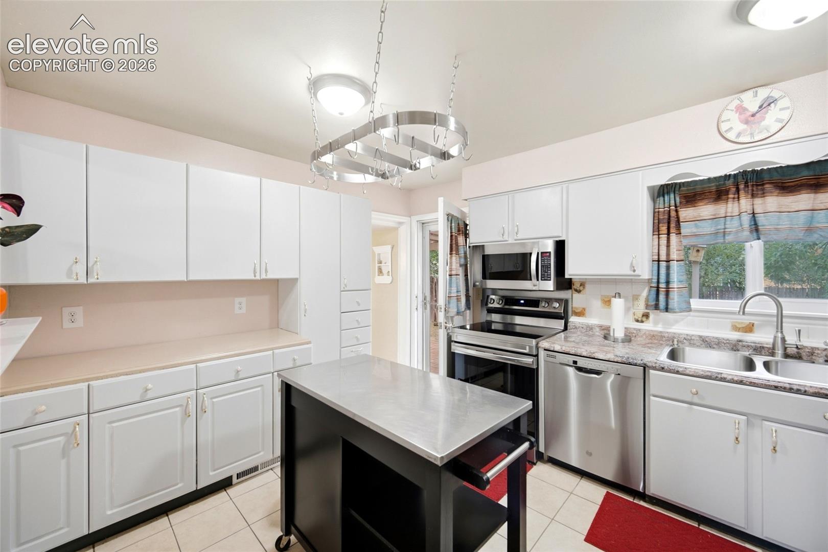 Extra Cabinetry in the kitchen. Bonus with movable island and Hanging Pan Rack! 