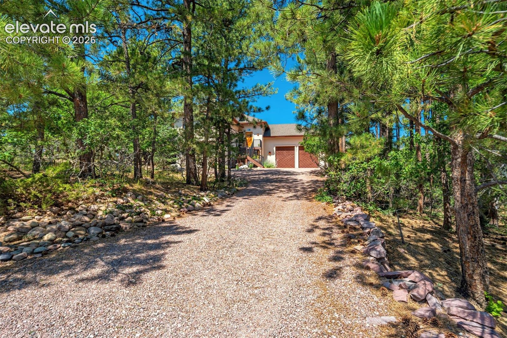 Home is tucked above seldom-used Greenwood Dr, set back from the road among mature old-growth pines, offering privacy, peace & a true mountain feel
