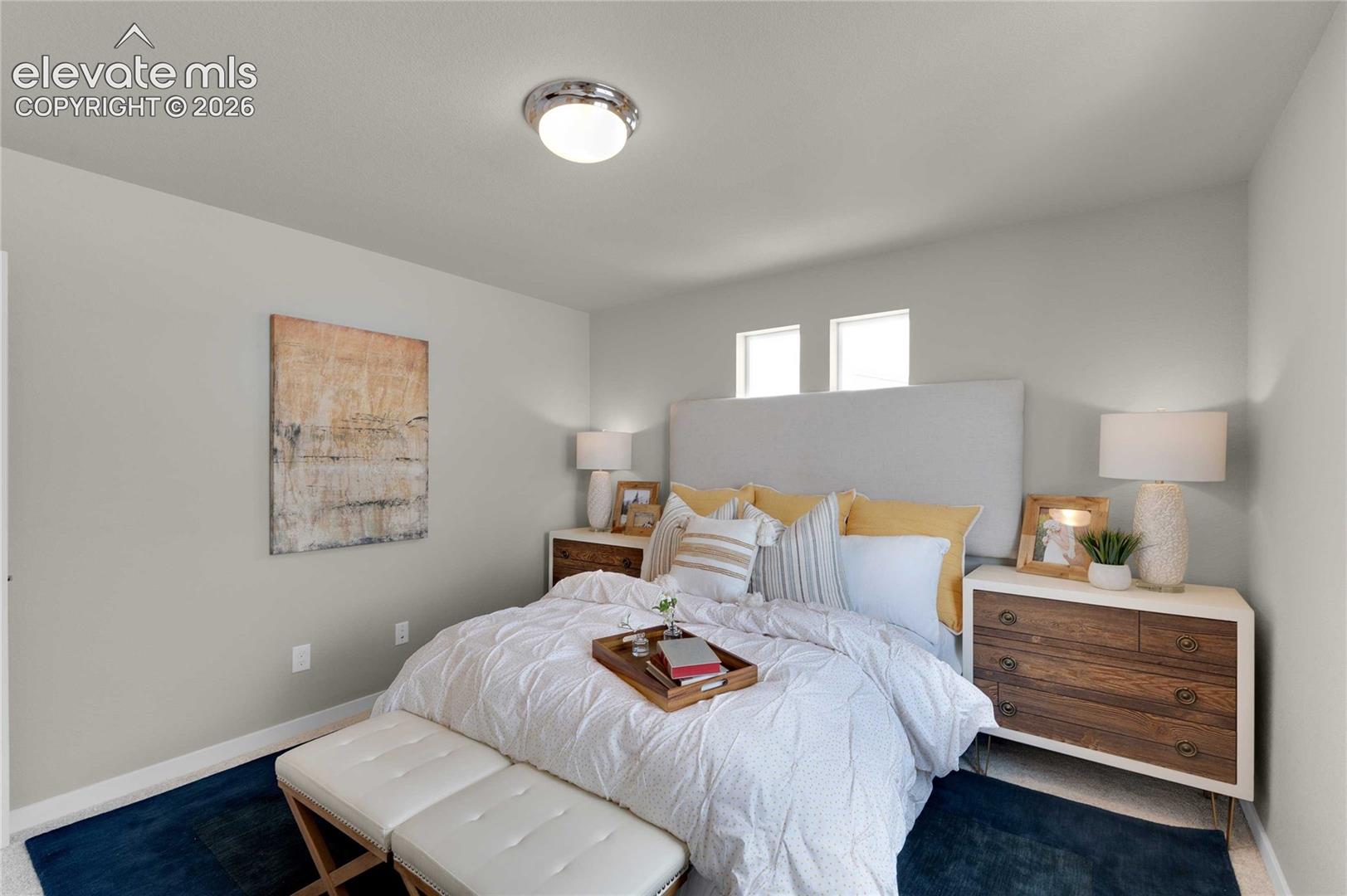Recessed windows, overhead flush mount lighting, light gray wall color, carpet flooring, and a white upholstered headboard
*photos of a model home*
