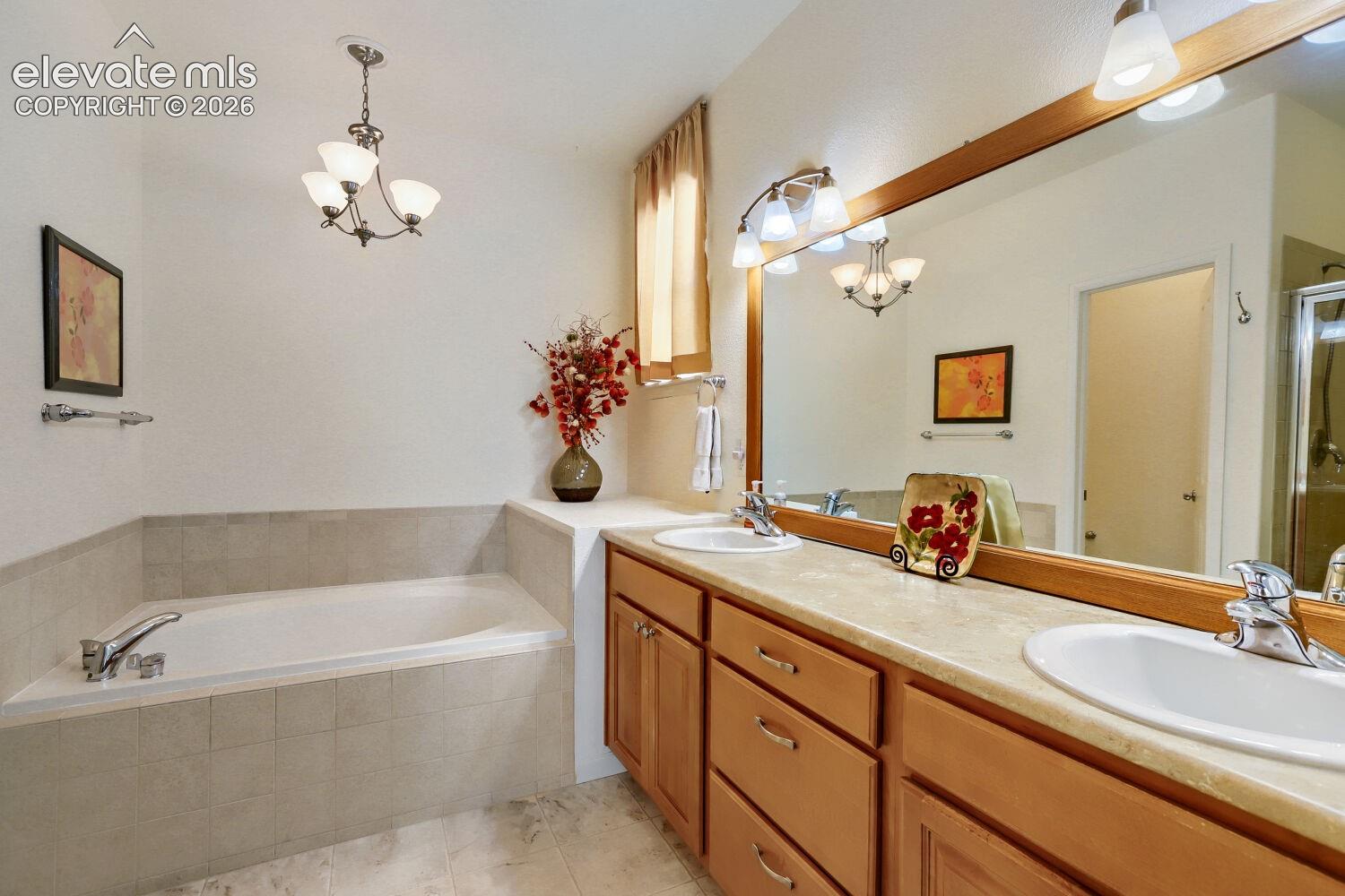 5 piece adjoining bathroom to include double sinks, soaking tub, separate shower, separate toilet area and a walk in closet.