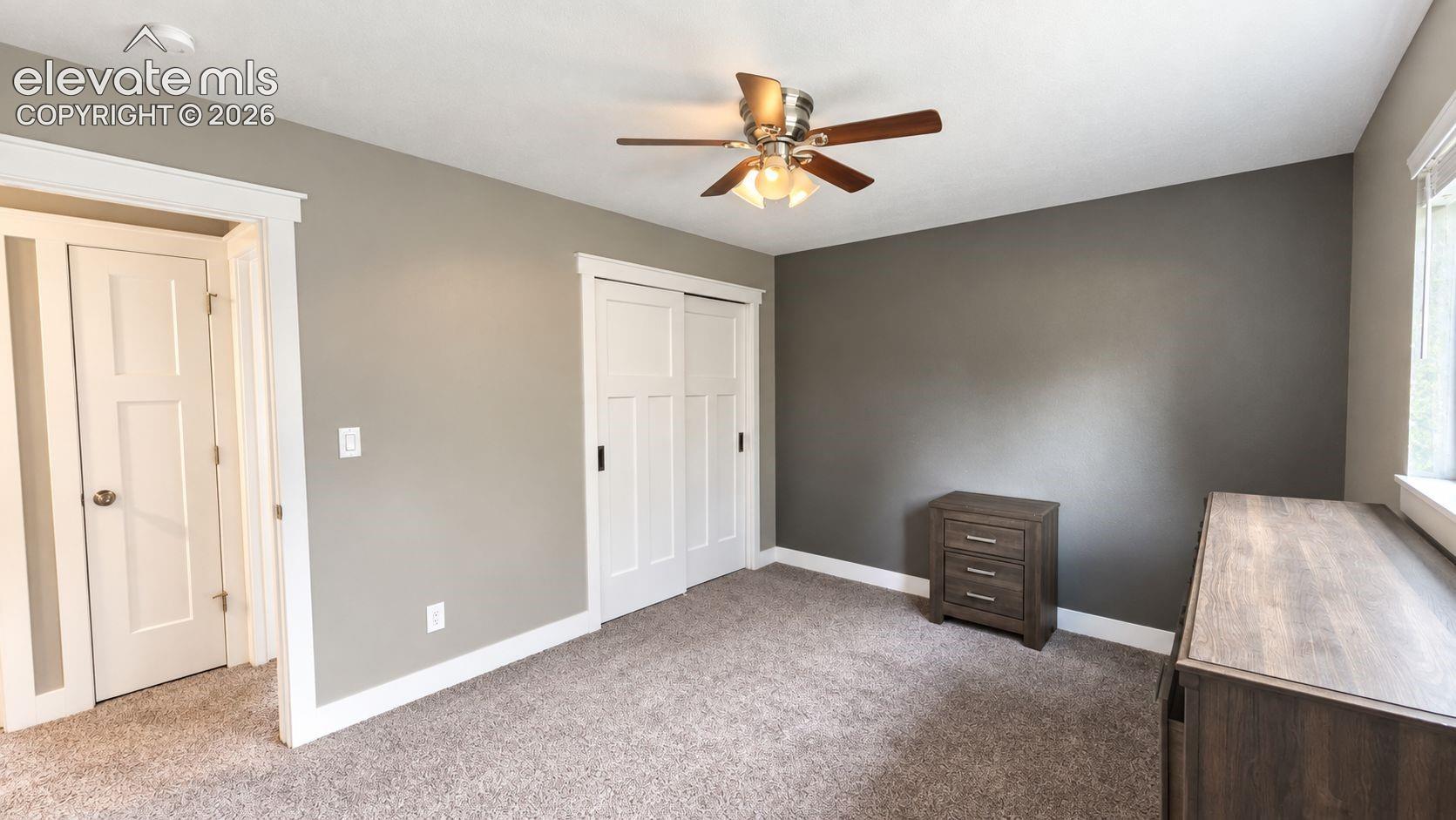 Neutral wall paint, white trim, and carpeted flooring