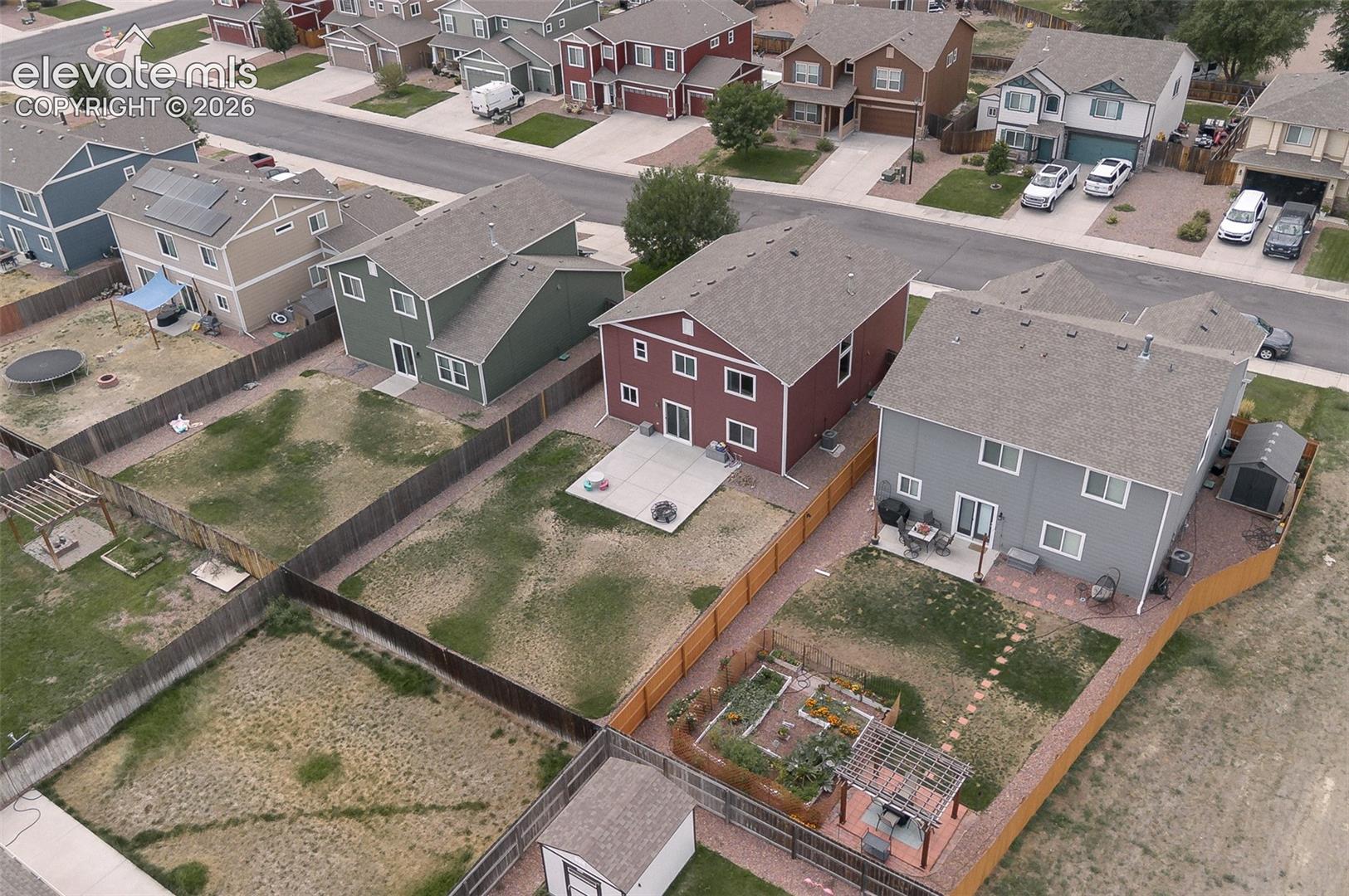 Aerial rear view of home and yard.