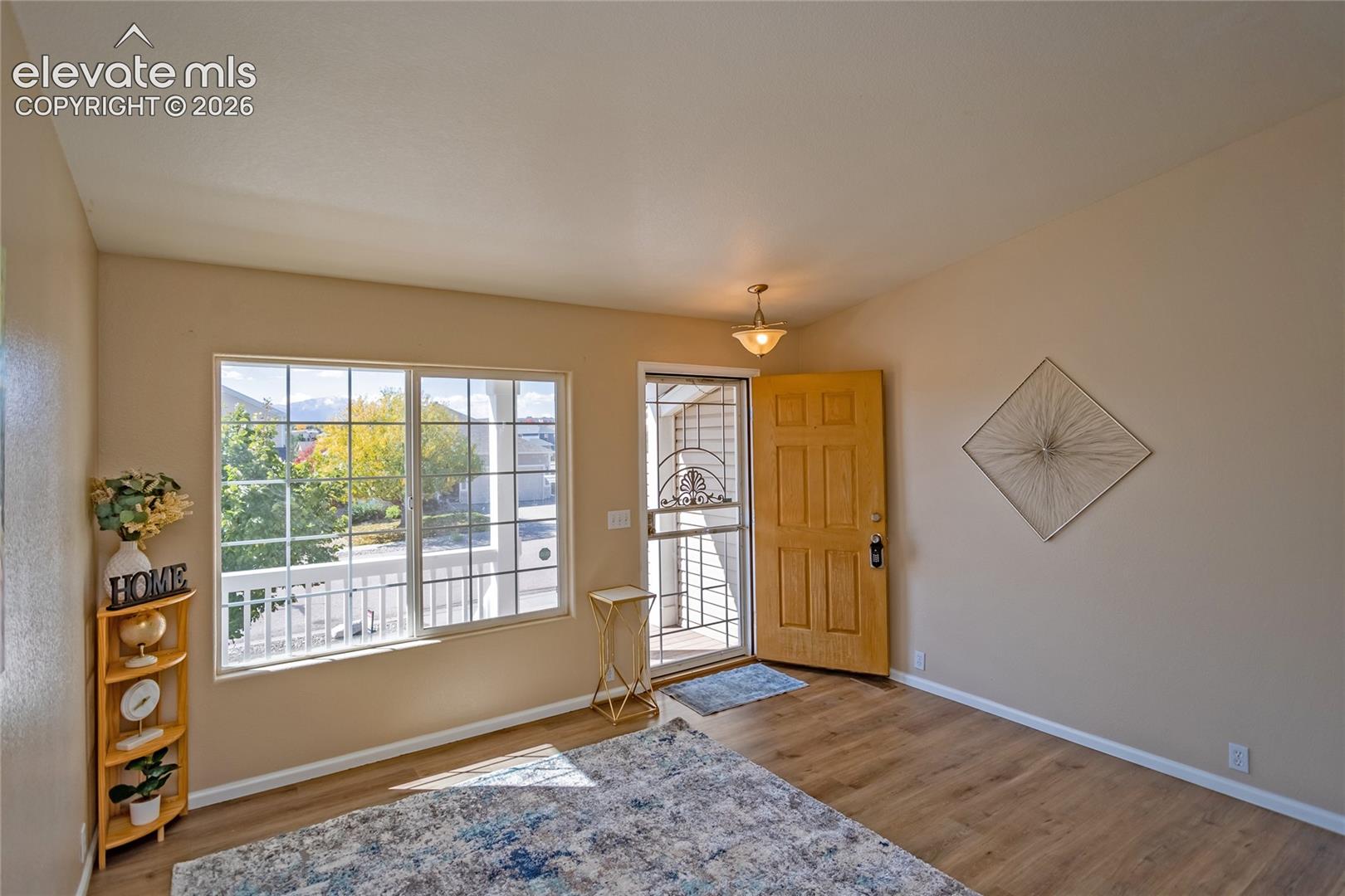 Step inside to a bright, sun-filled living space featuring brand-new luxury vinyl plank (LVP) flooring and vaulted ceilings