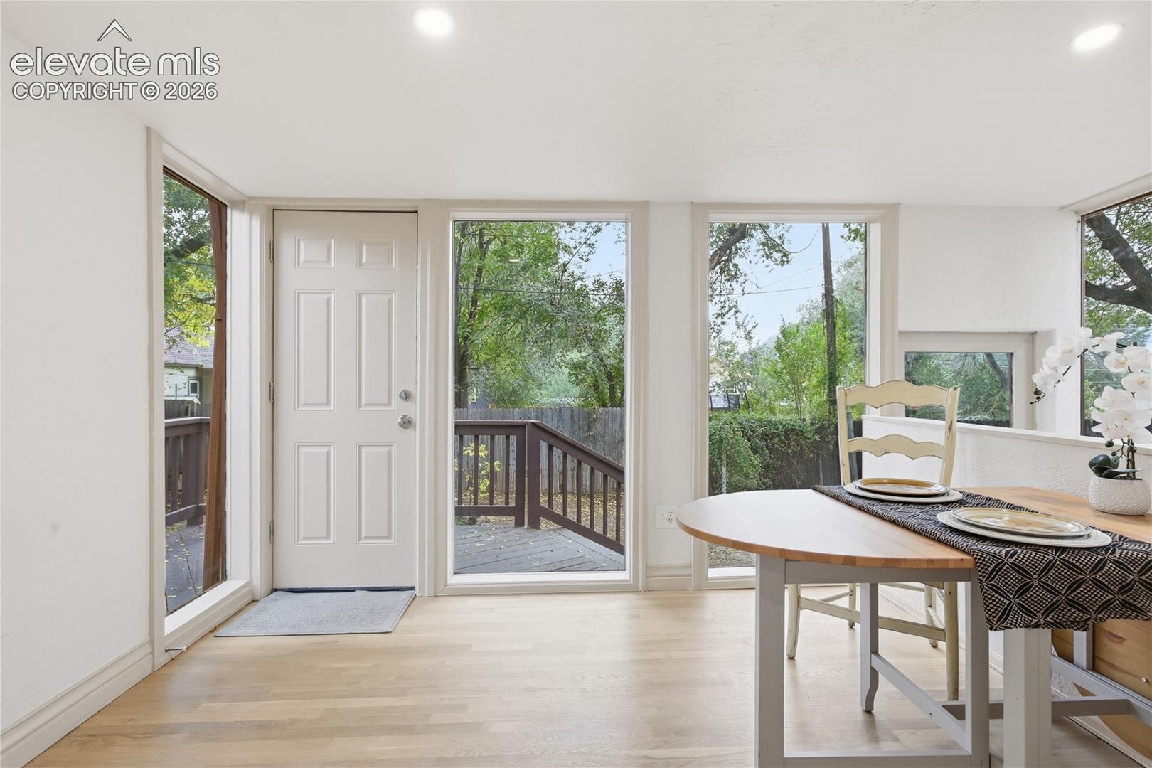 Interior space featuring light-toned wood-finish flooring, recessed lighting, and expansive floor-to-ceiling windows