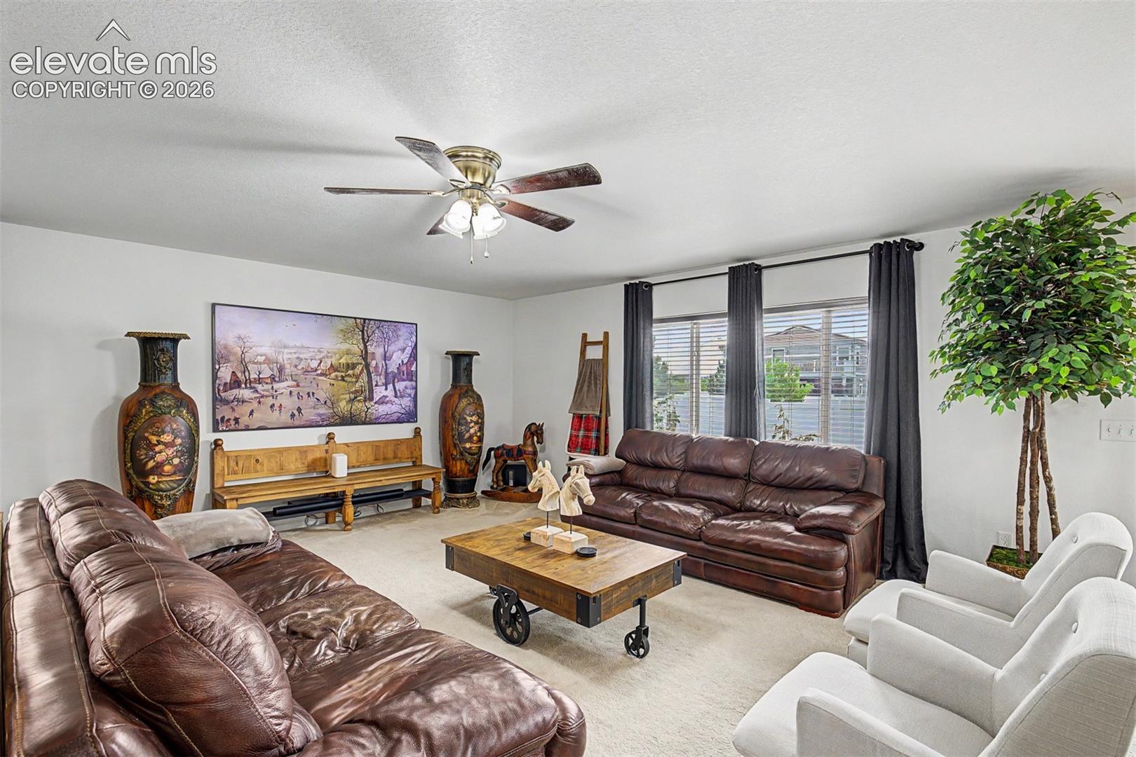 Natural light pours through multiple windows in this expansive main living room.