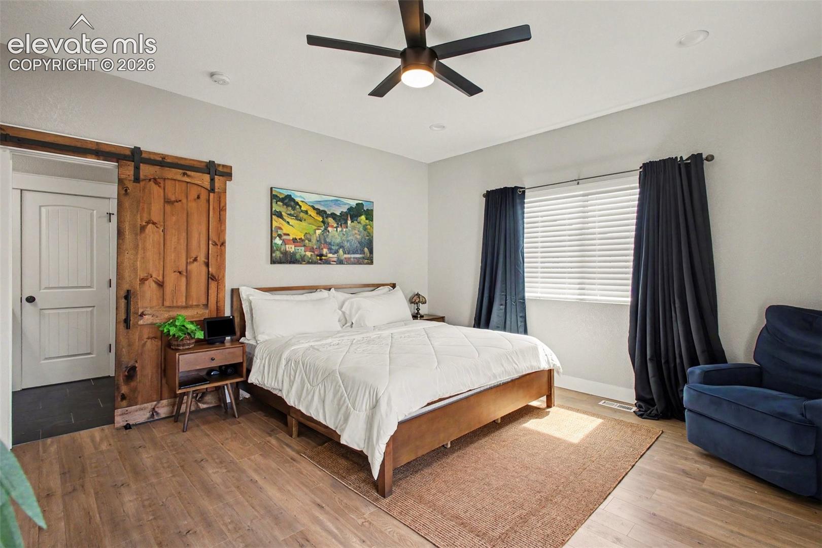 The main-level primary suite serves as a private retreat with access to its own composite deck, a luxurious five-piece bath with dual vanities, soaking tub, separate shower, and a generous walk-in closet. 