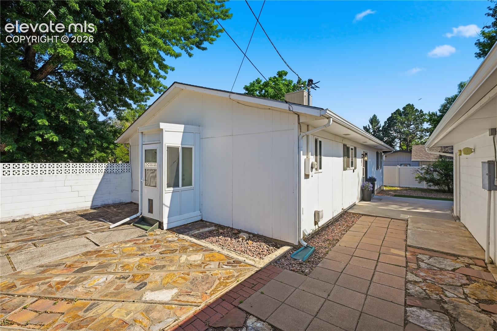 Charming side entry and private courtyard area add character while creating a functional transition between the home and garage.