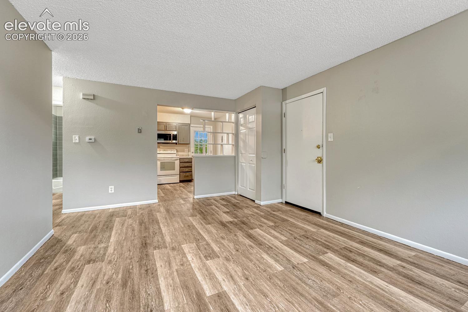 Wood-finish flooring throughout, light gray wall paint, and white trim
