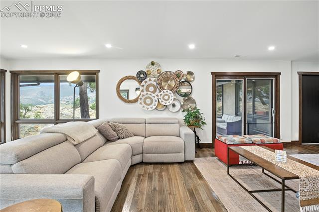 Living room with plenty of natural light, recessed lighting, and wood finished floors