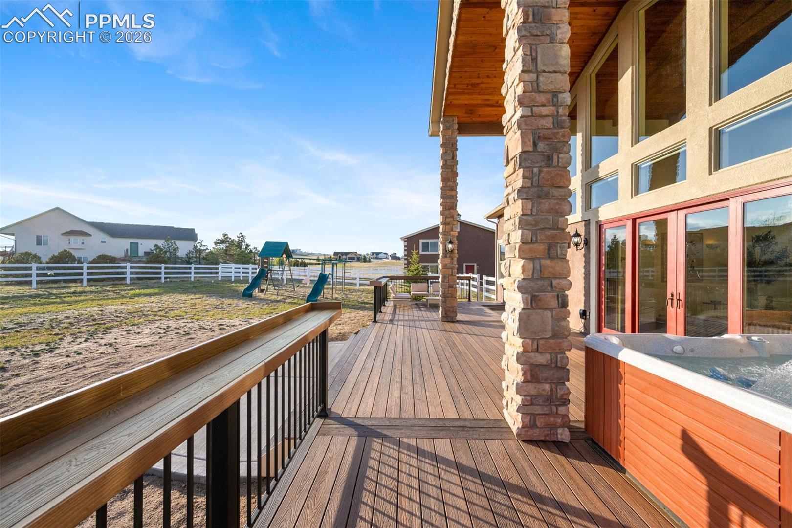 Deck with custom pillars and 2 story overhang matching the ceiling inside