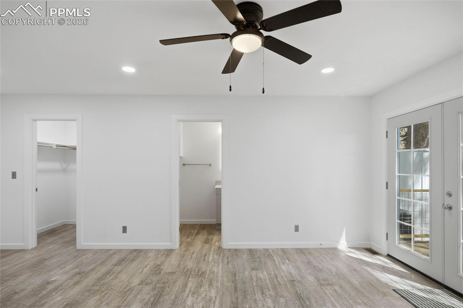 View into walk-in closet & bath