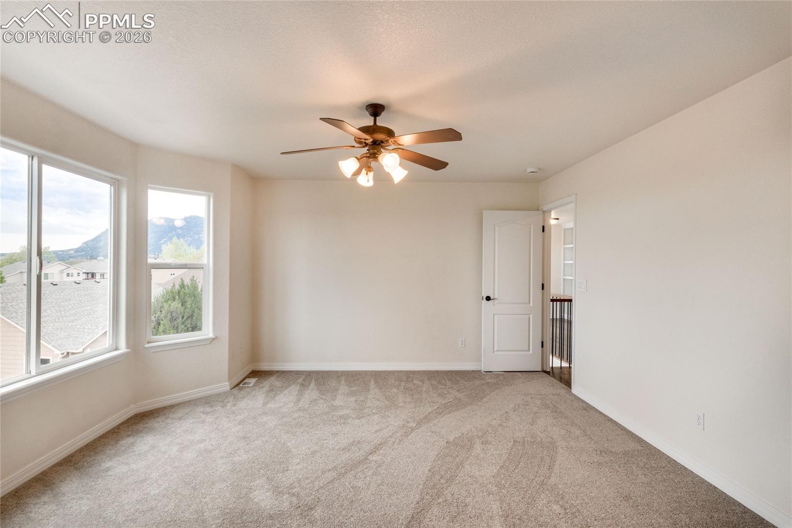 Spacious primary bedroom with an abundance of natural light.