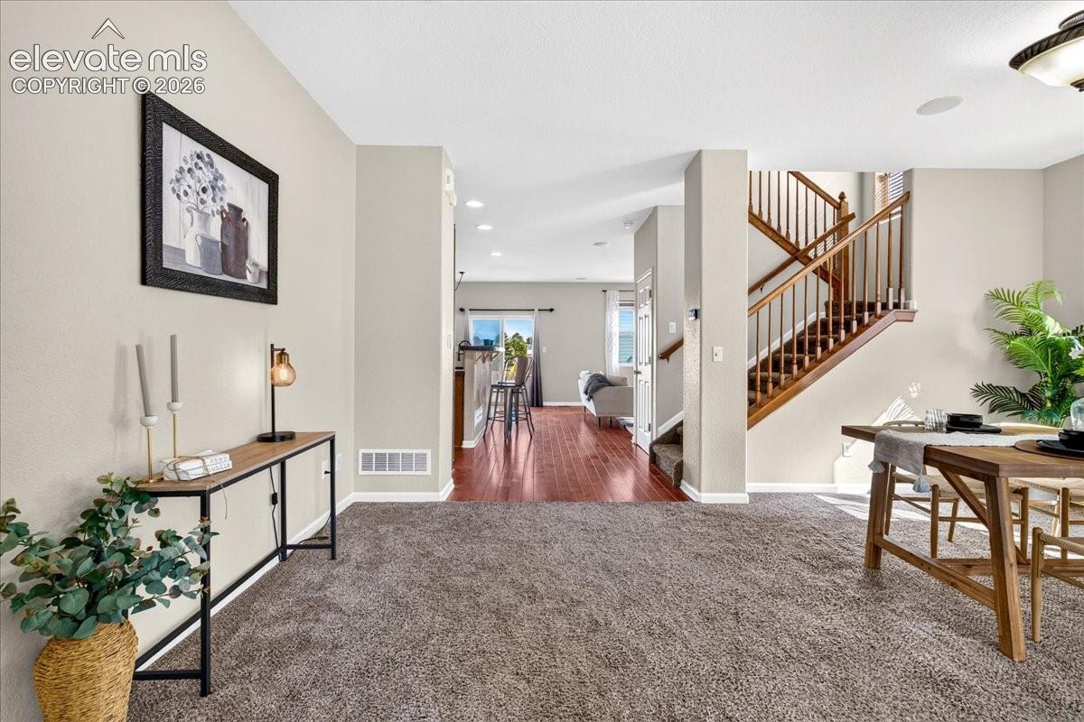 Neutral-toned walls complement the carpeted and wood-finish flooring