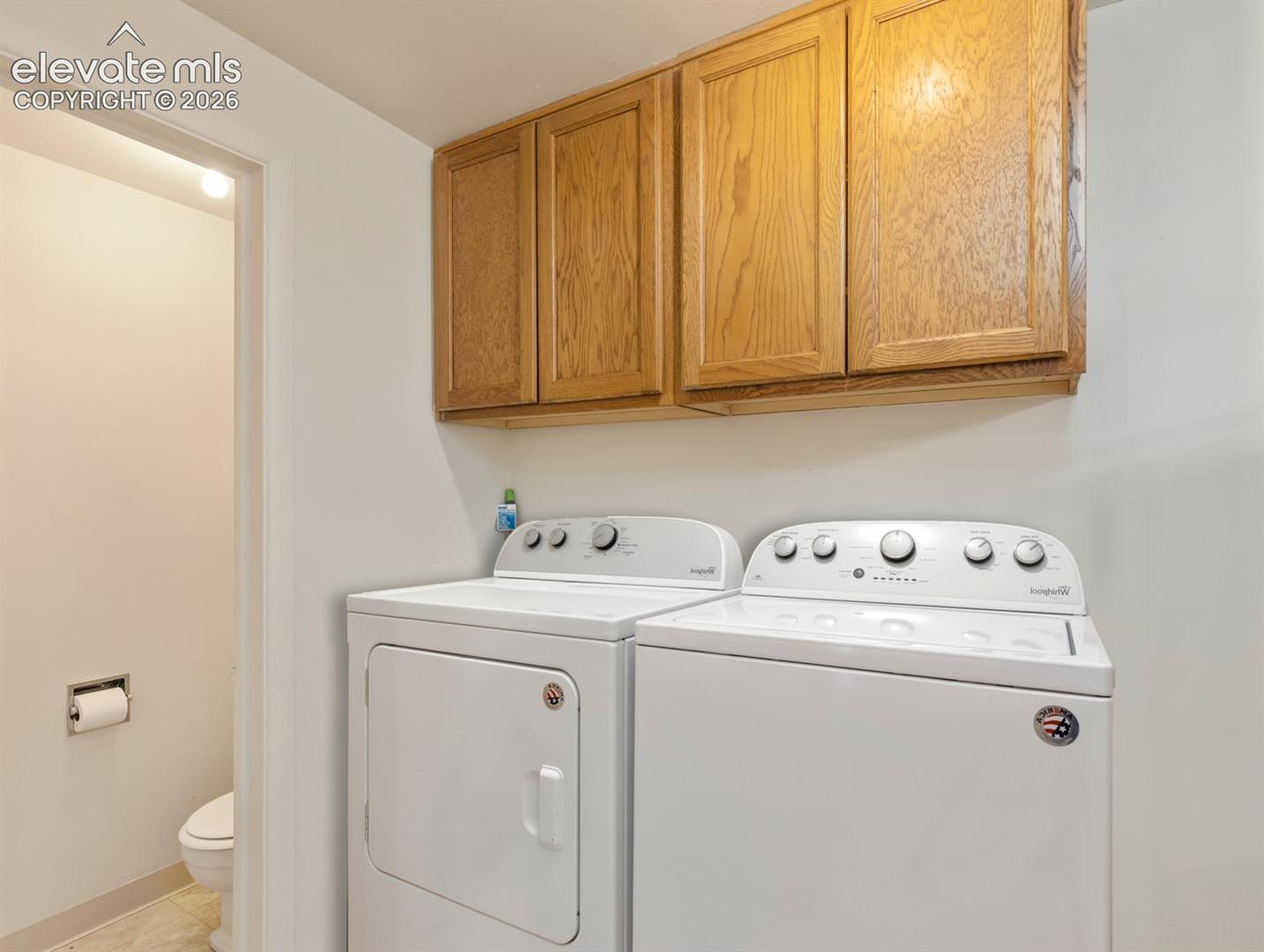 Main level laundry room is off the kitchen near the back door