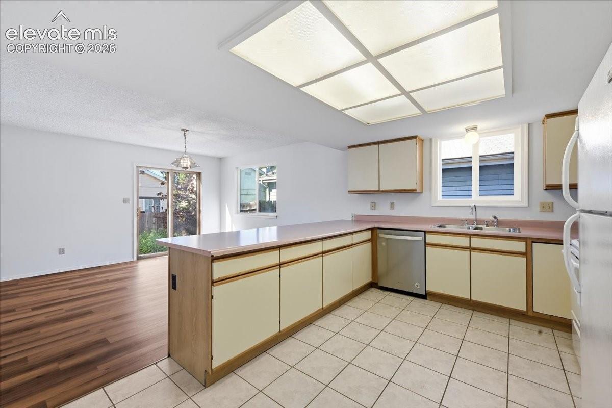 Kitchen with dining space and a sliding door to the patio at , Colorado Springs, CO.