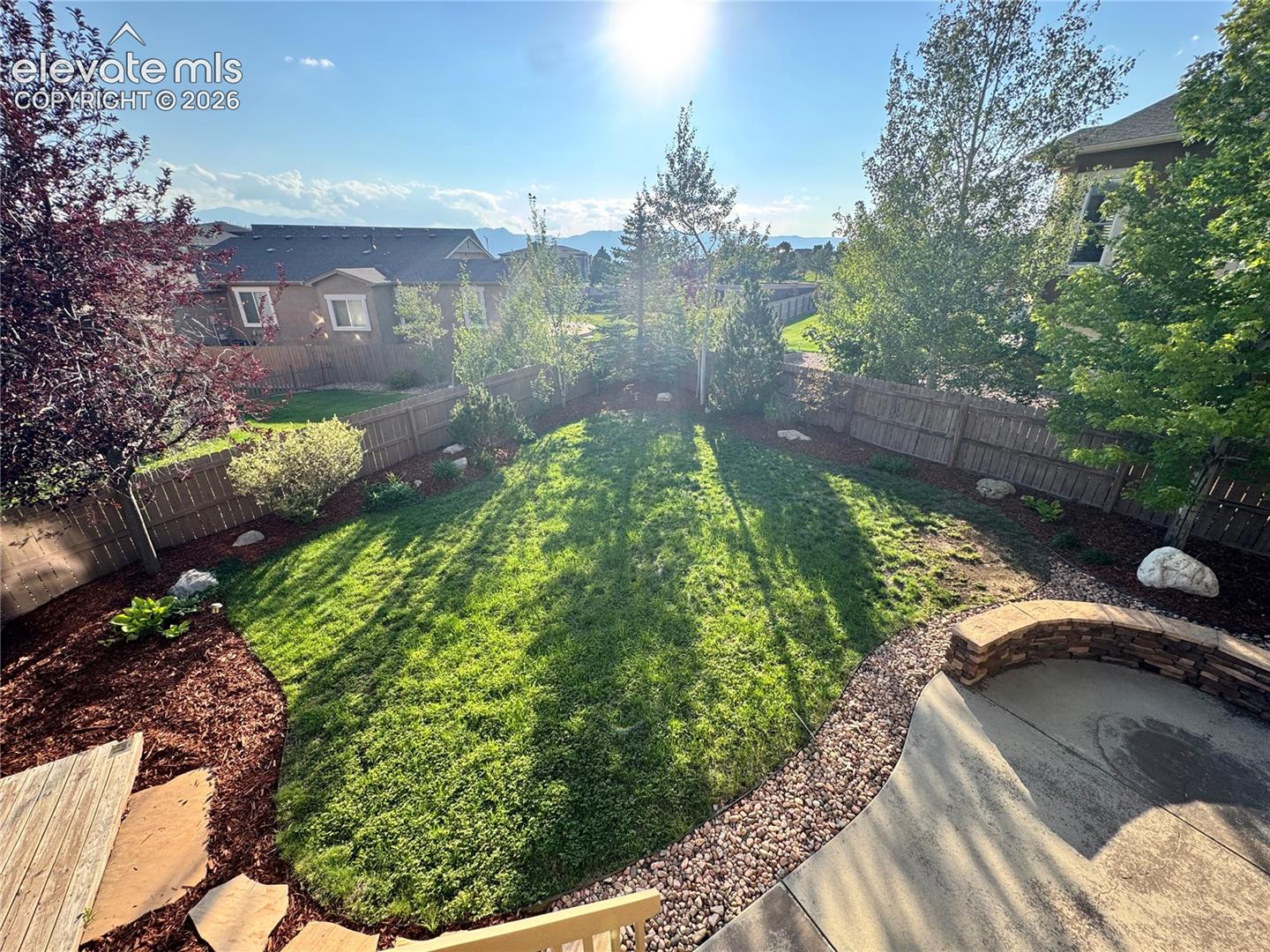 The deck not only offers great views of the mountains but overlooks the entire fenced backyard; with updated landscaping, towering trees and plenty of space for entertaining. 