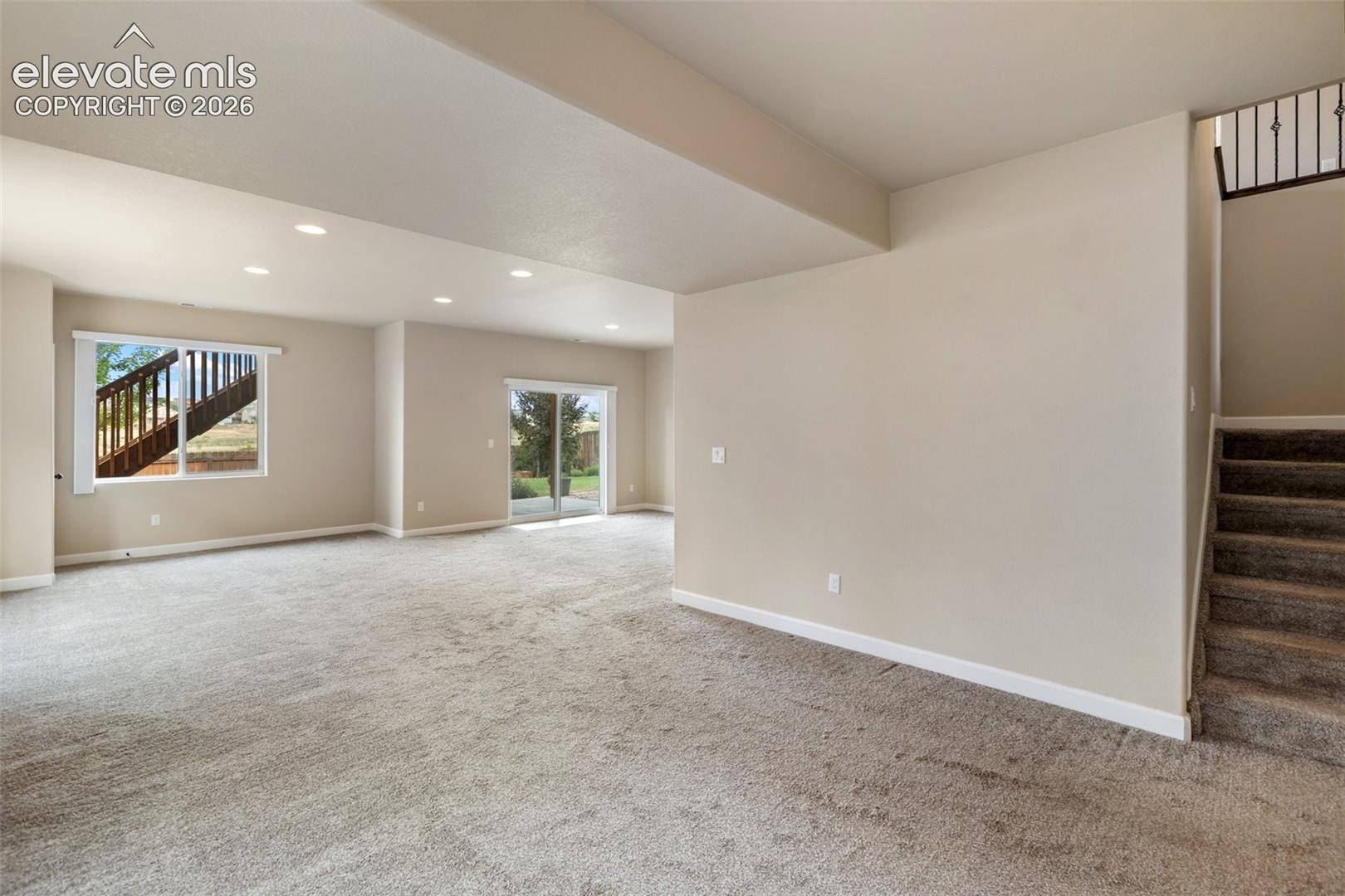 Coming down the stairs opens to the Large Family Room