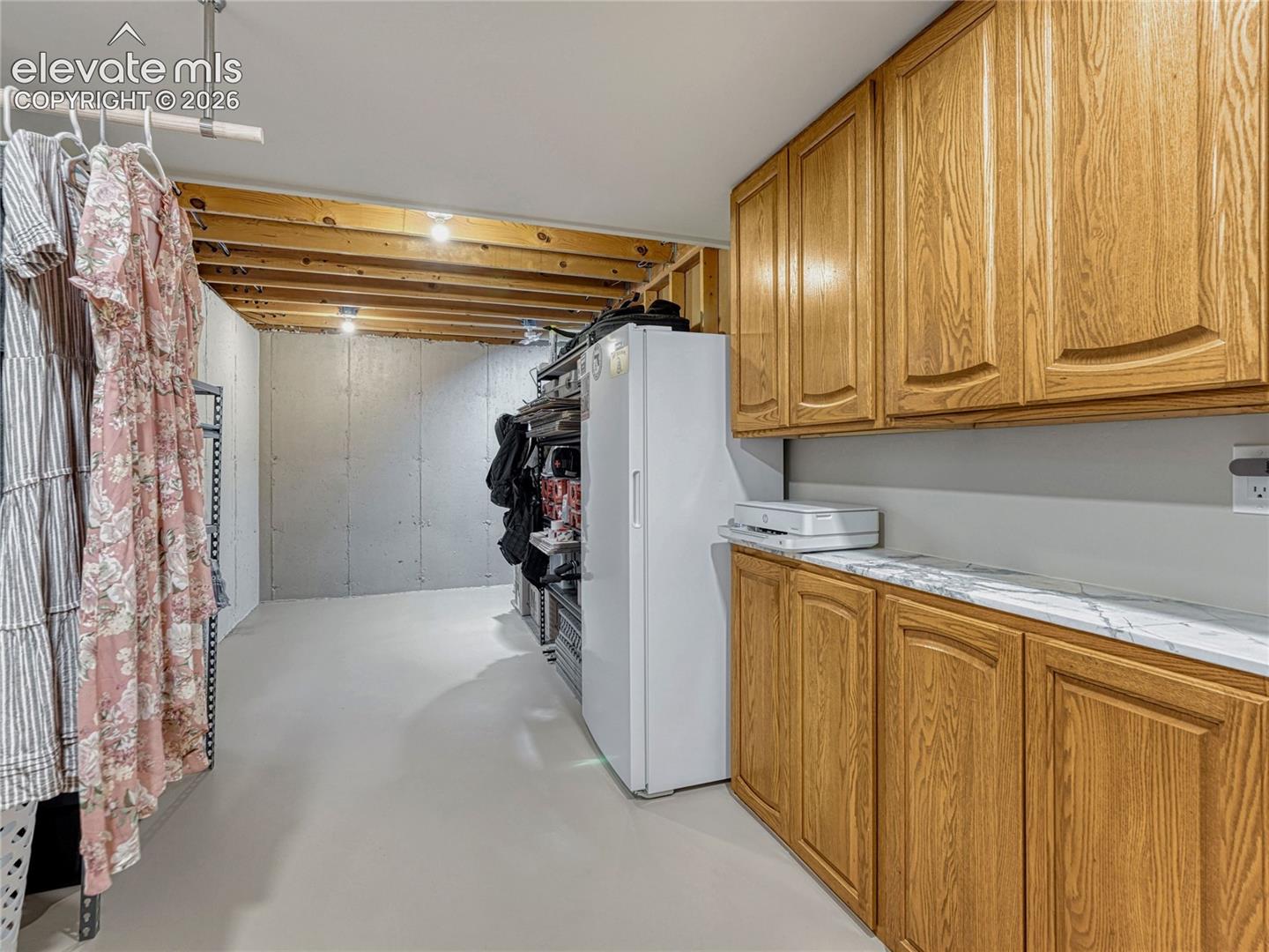 Laundry w/ sink and storage area.