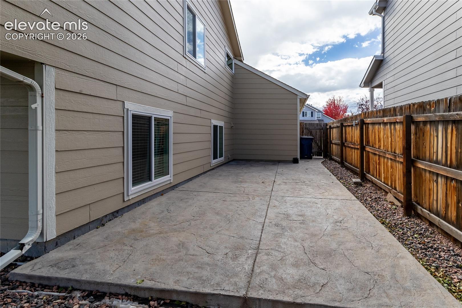 Additional stamped concrete patio on the side of the home.