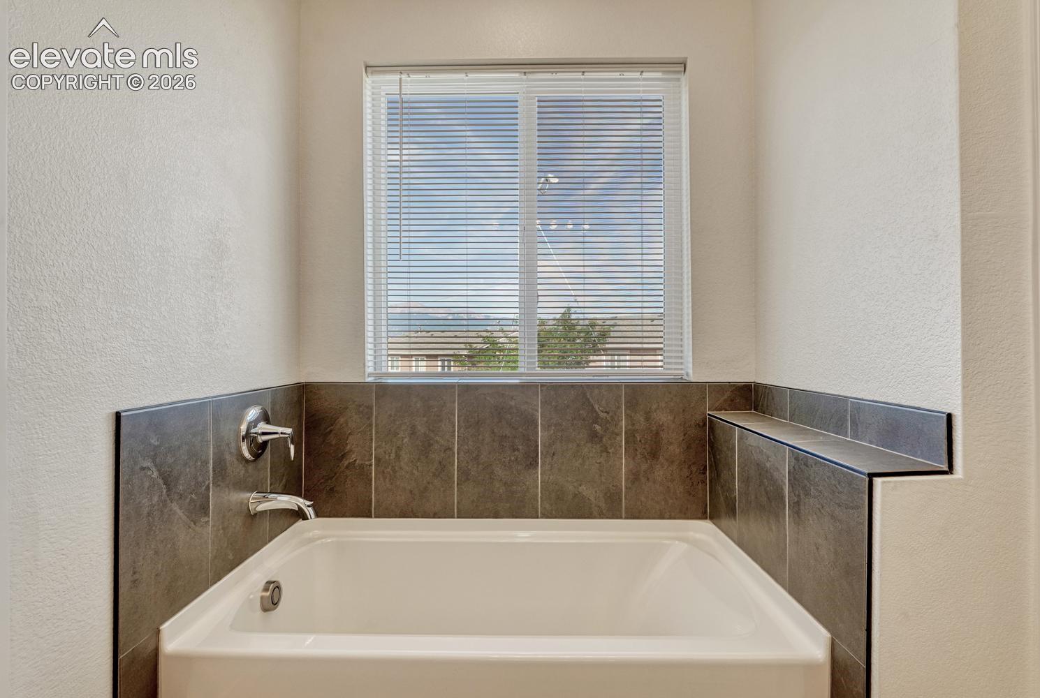 Soaking tub with Pikes Peak view!