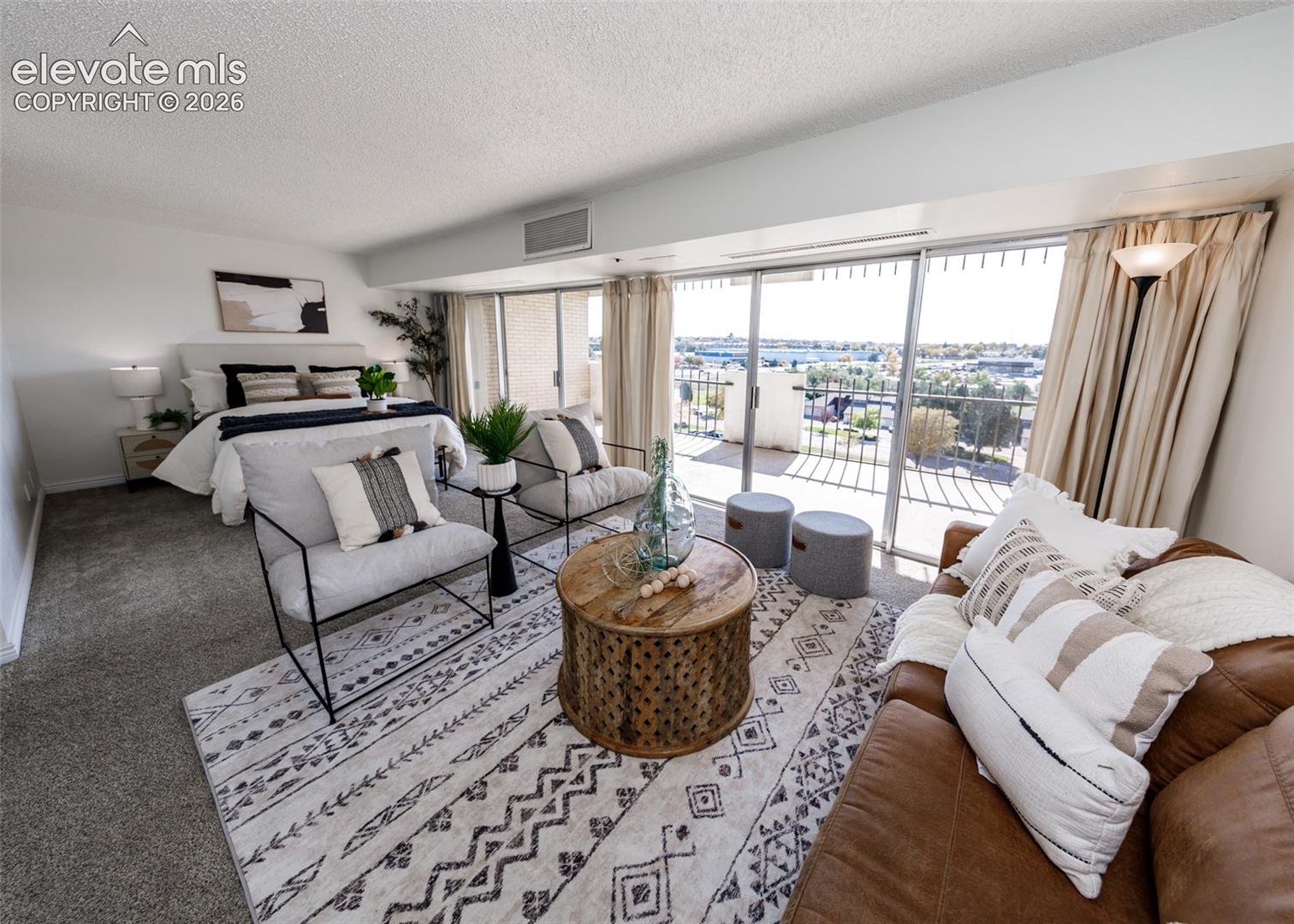 Wall-to-wall carpeting, floor-to-ceiling sliding glass doors, and a private balcony with exterior railing