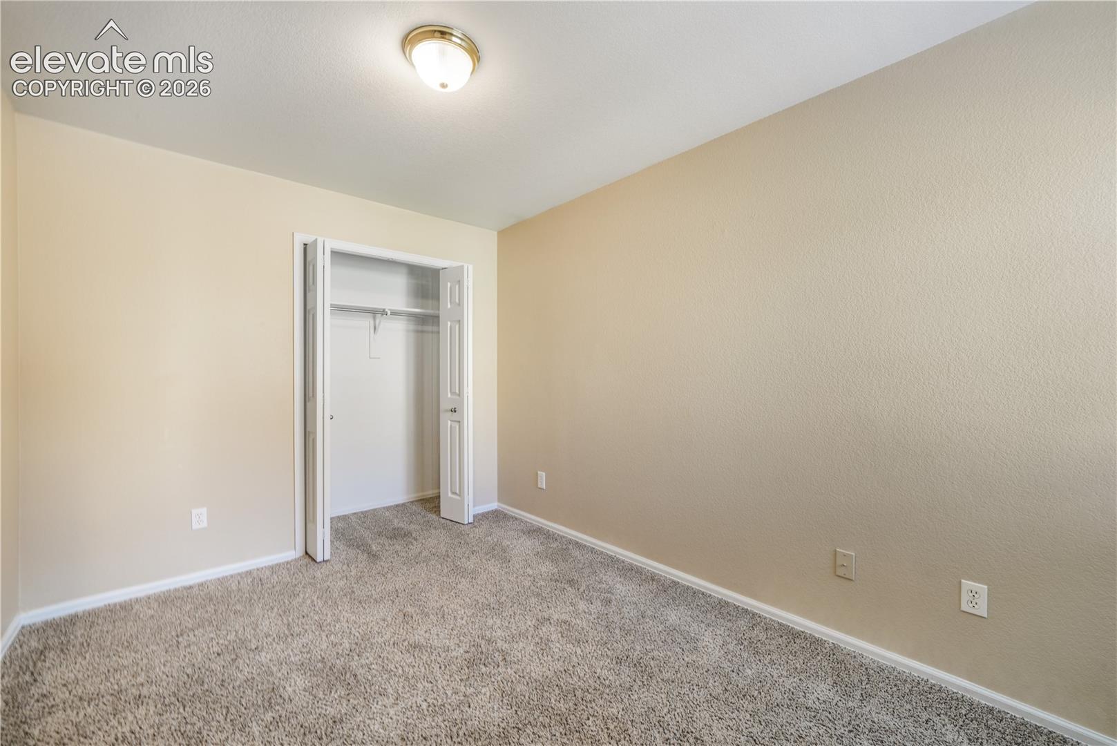 First bedroom, main floor at front of home with connecting access to the 3/4 bathroom