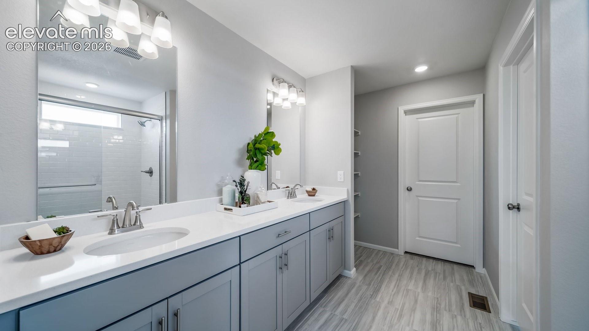 Double vanity with integrated sinks, white countertops, and brushed nickel faucets
Photos of a model home