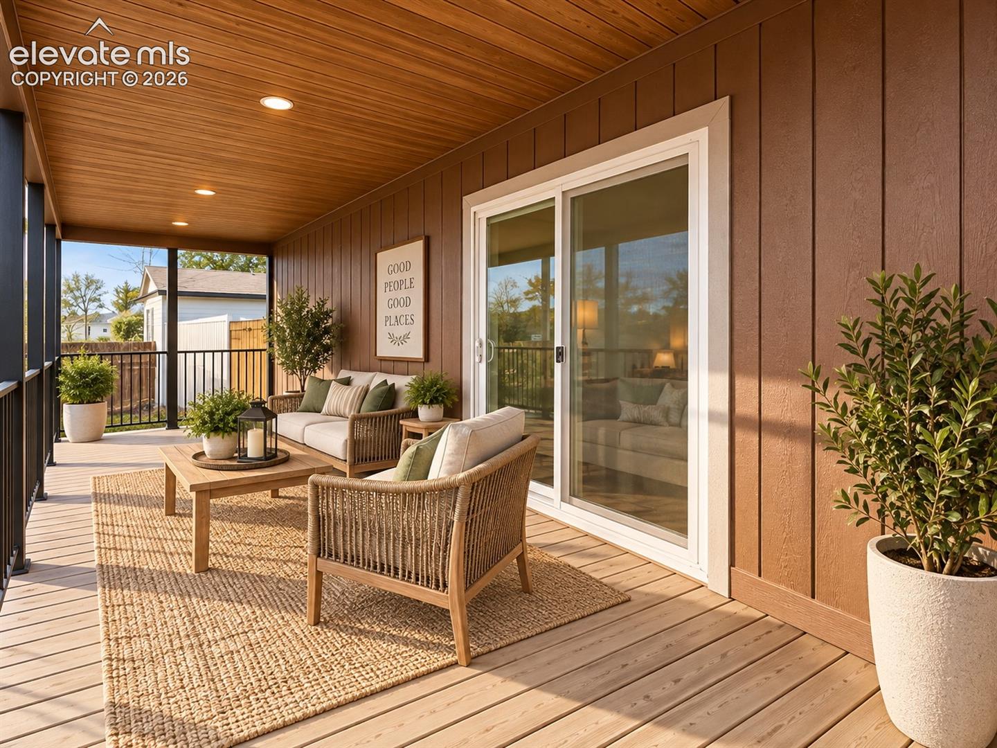 Covered Porch – Another porch view highlights the substantial outdoor living space, recessed ceiling lights, sliding-door access to the interior, and room for multiple seating arrangements.
