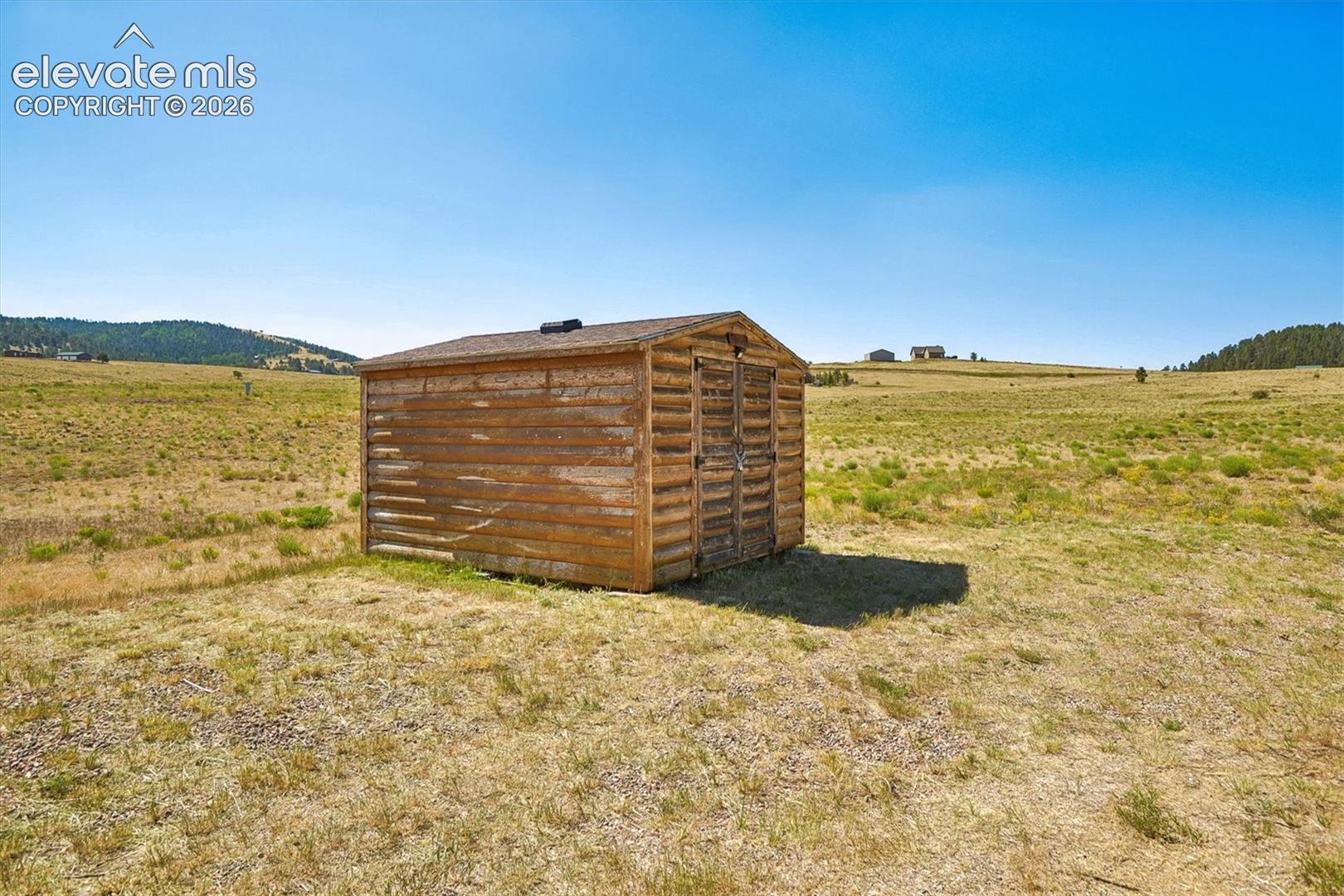 Freestanding wood-sided shed with a sloped roof