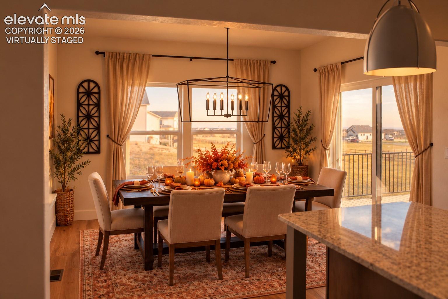 Virtually staged Dining area featuring wood-finish flooring, a contemporary linear chandelier, and a sliding glass door leading to an outdoor balcony with metal railings