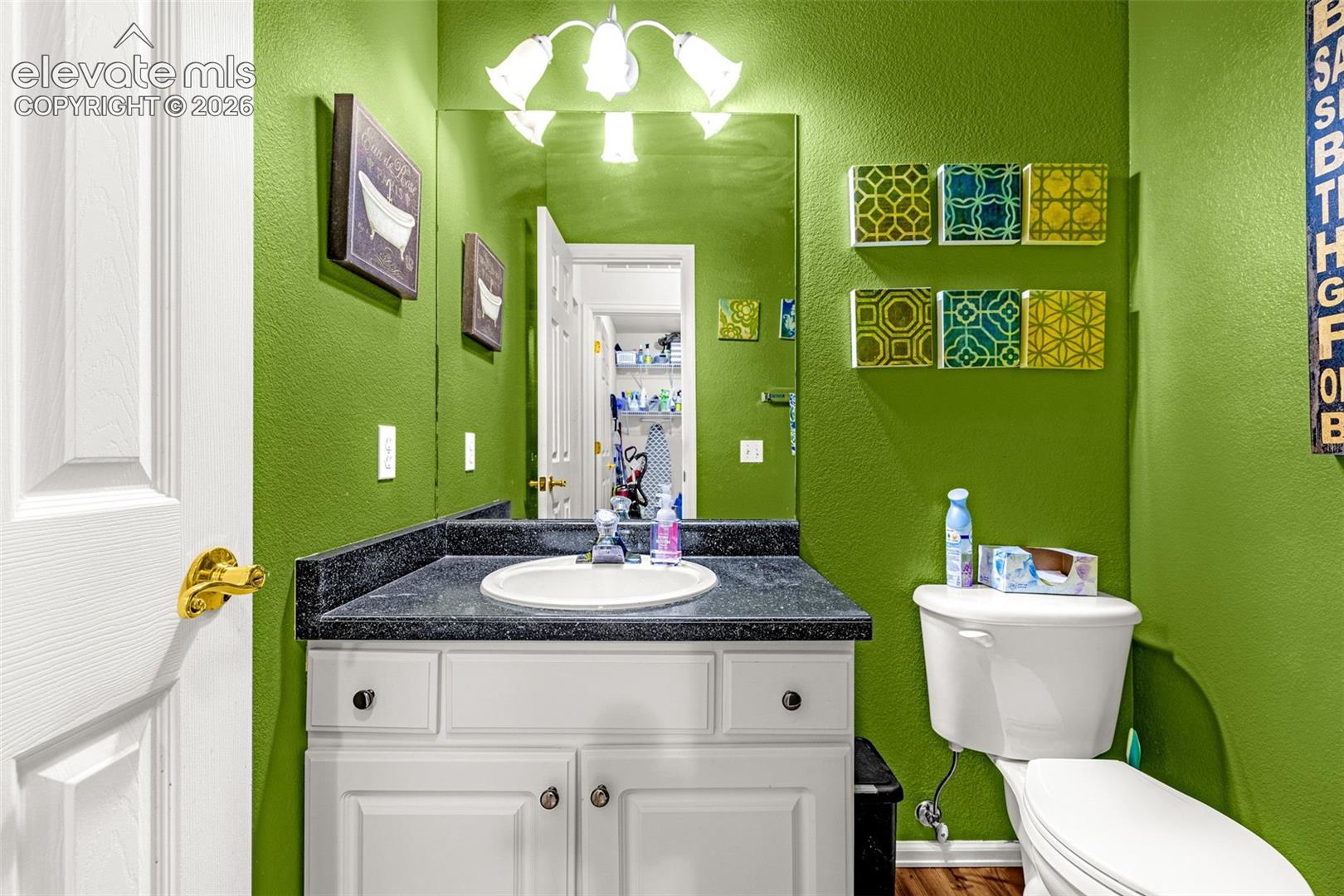 White vanity with a black countertop and an integrated sink
