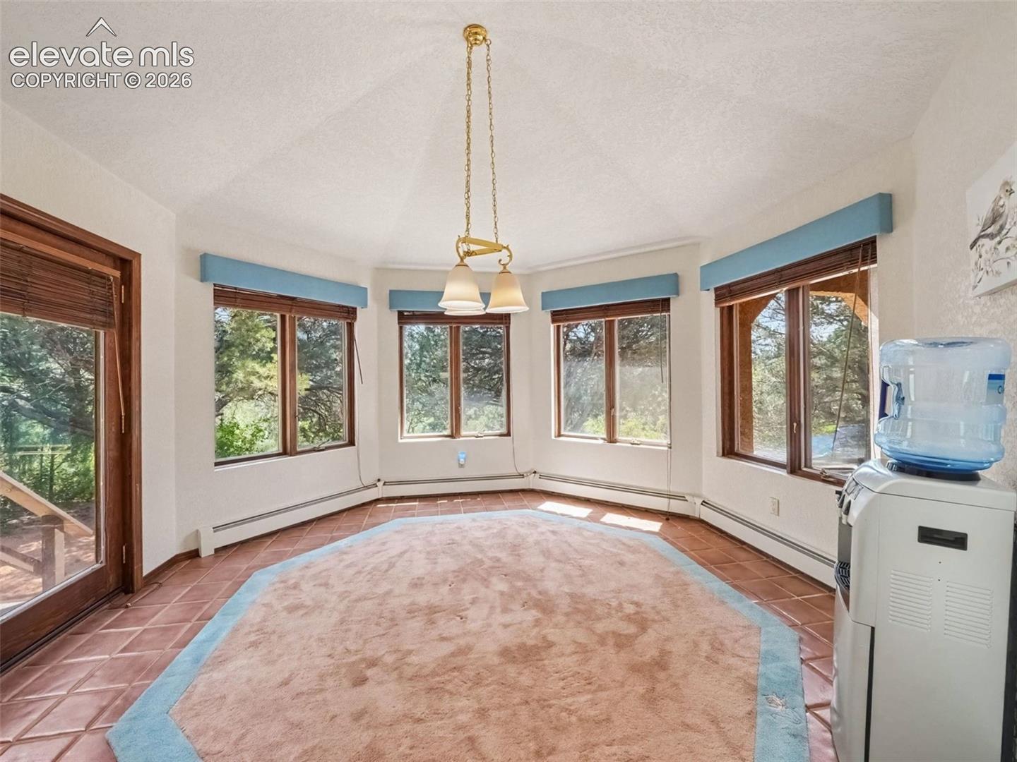 Distinctive diamond-shaped dining area offers a unique architectural touch, with a walkout providing easy access to the outdoor space and surrounding views