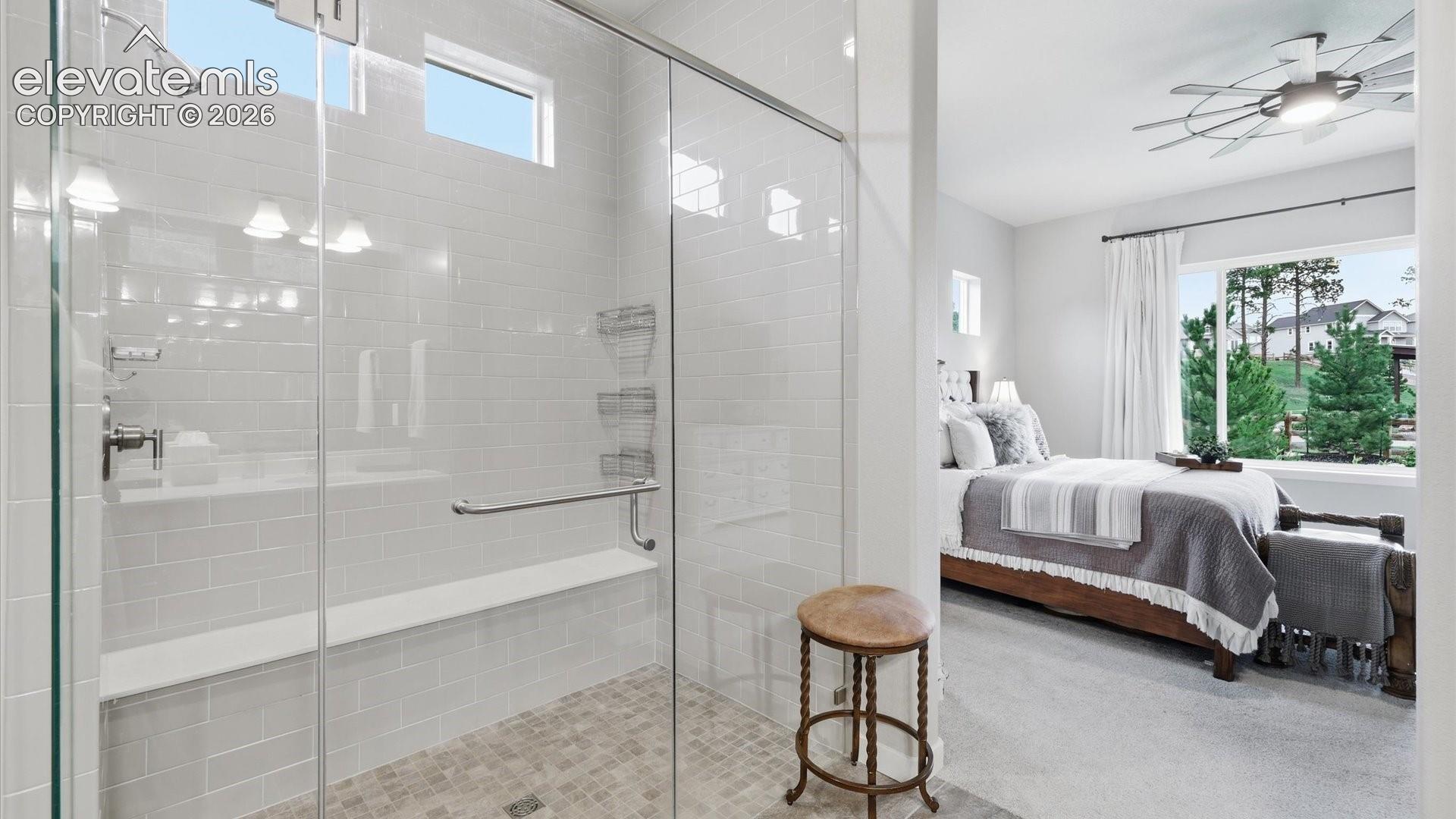 SPA-INSPIRED ELEGANCE — A beautifully designed walk-in shower with a sleek glass enclosure and timeless subway tile surround creates a fresh, sophisticated retreat.