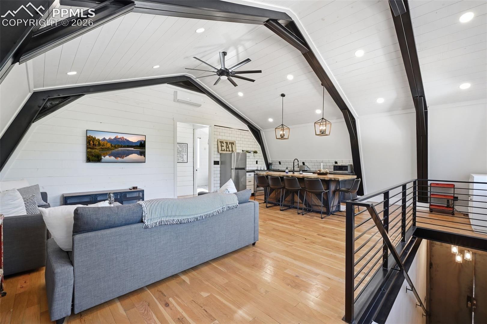 Apartment living room features oak hardwood floors and soaring ceilings. 