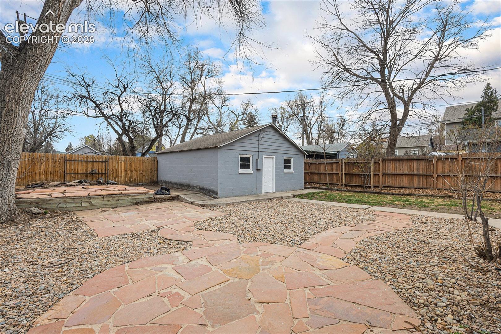 Beautifully, low maintenance xeriscaping in back yard with alley access to garage