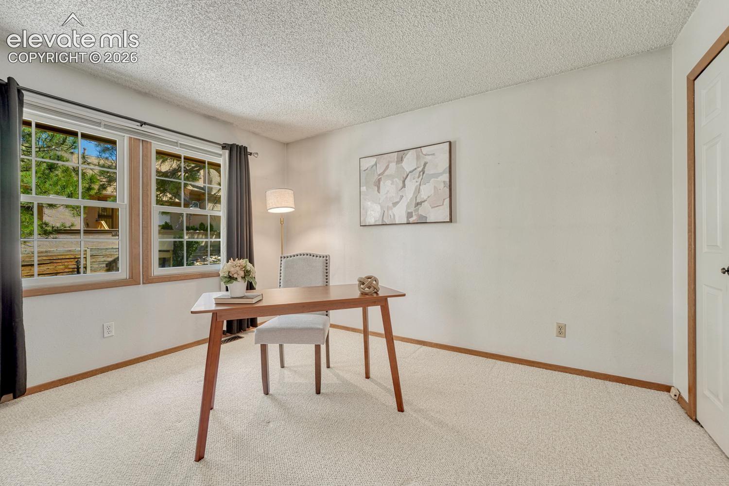 Upper Level Bedroom #2 (currently an office) has neutral carpet, large windows, and a generous closet.