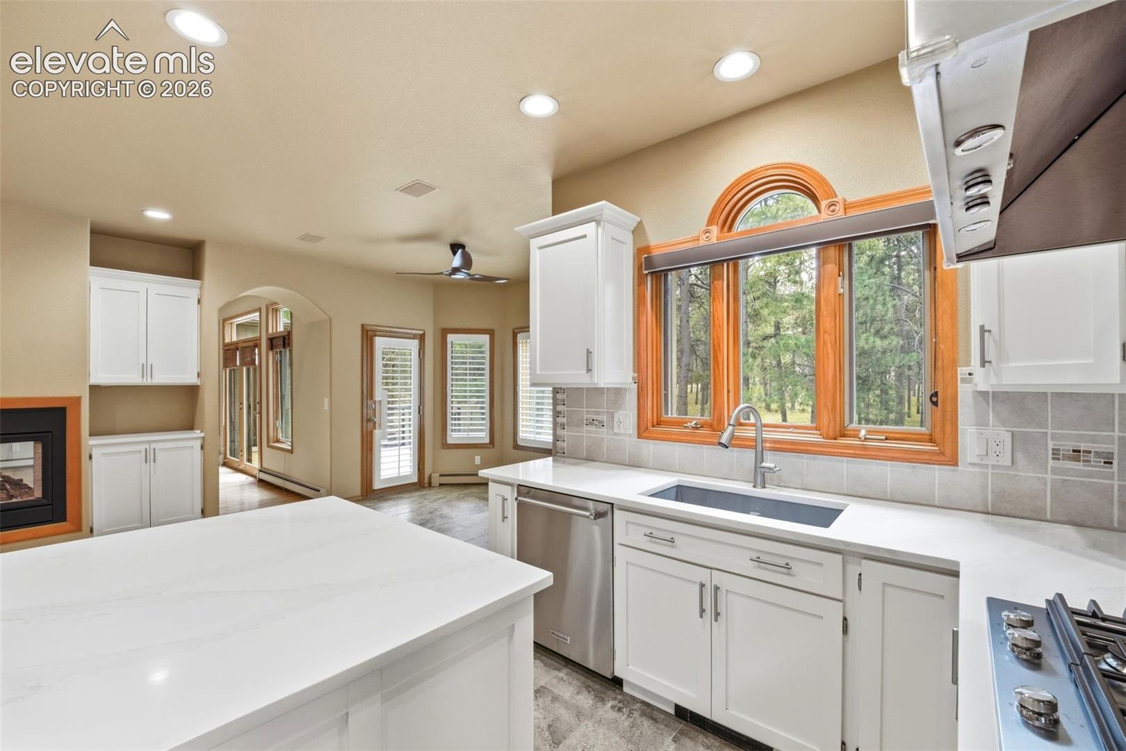 Modern kitchen featuring a large island with a light-toned countertop