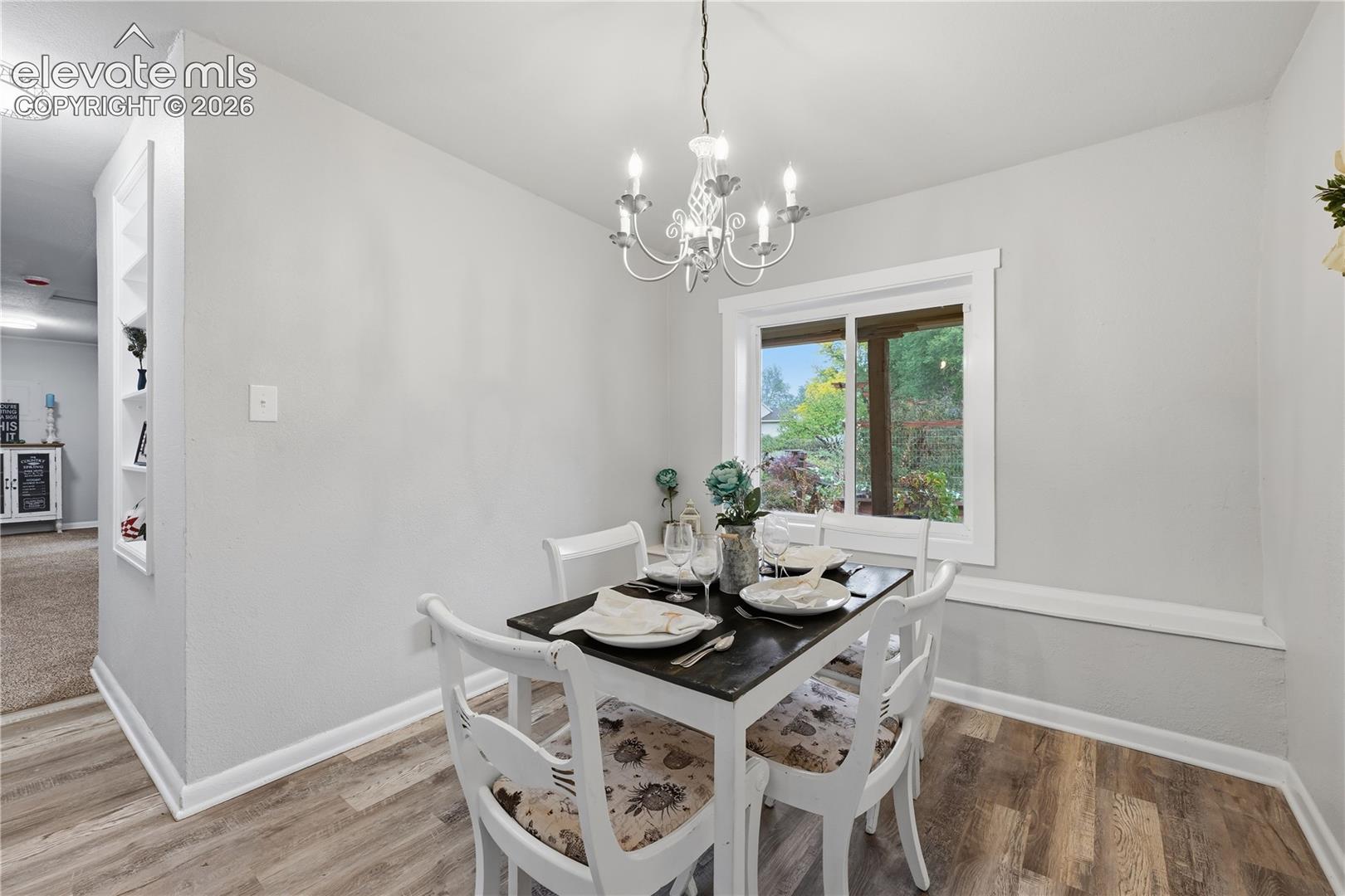 A formal dining room. There is a bench seat under the window also.