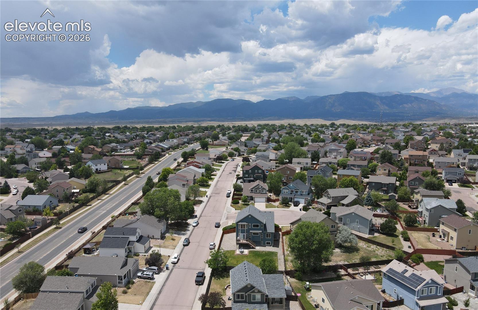 Residential area featuring multiple single-family homes with pitched roofs, some including solar panel installations