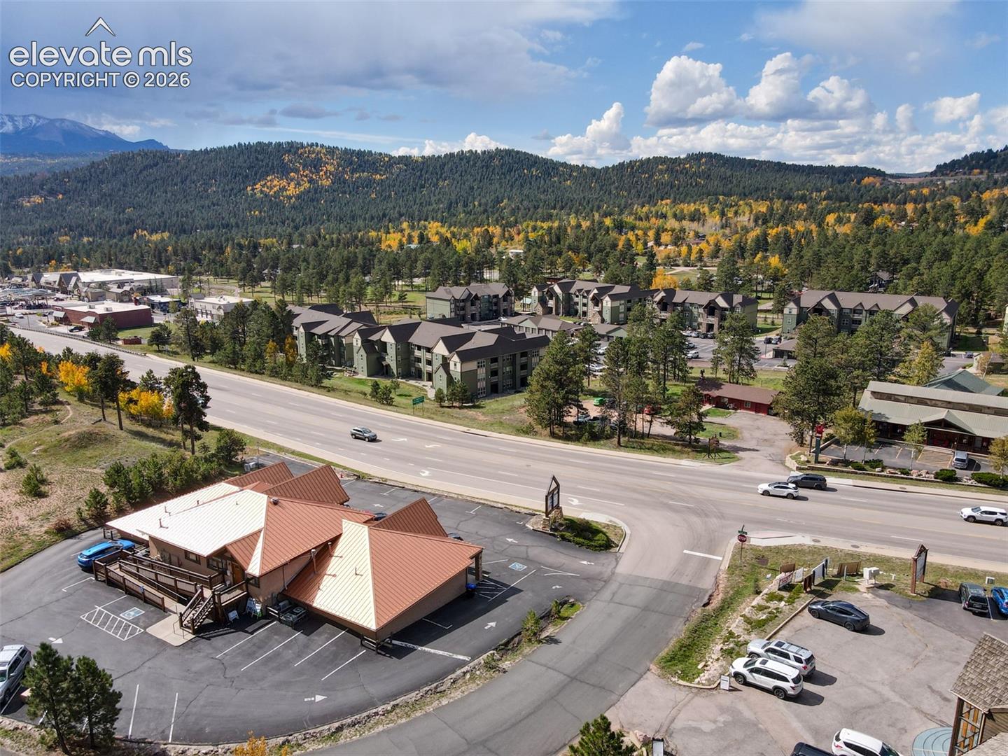 Commercial property with a distinct, multi-gabled roofline and ample paved parking