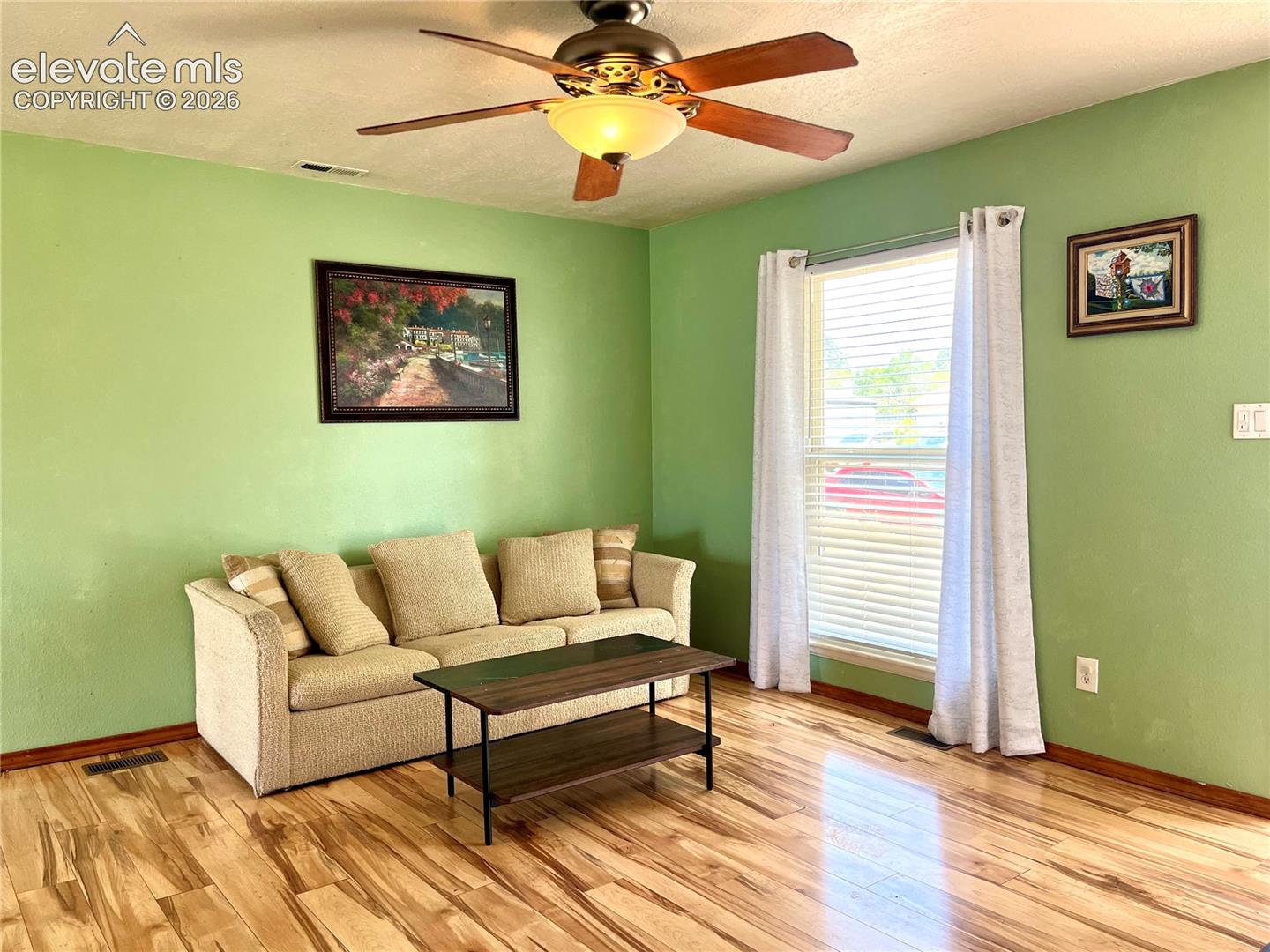 Bright living room with laminate wood flooring