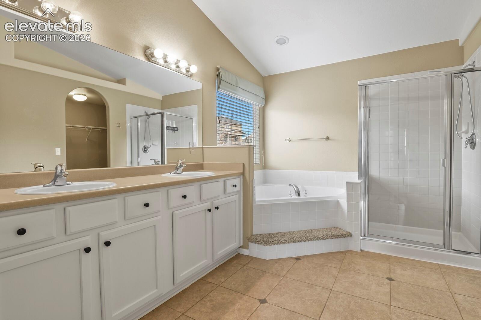 Dual sink vanity with white cabinetry and dark hardware, Warming Tile Floor