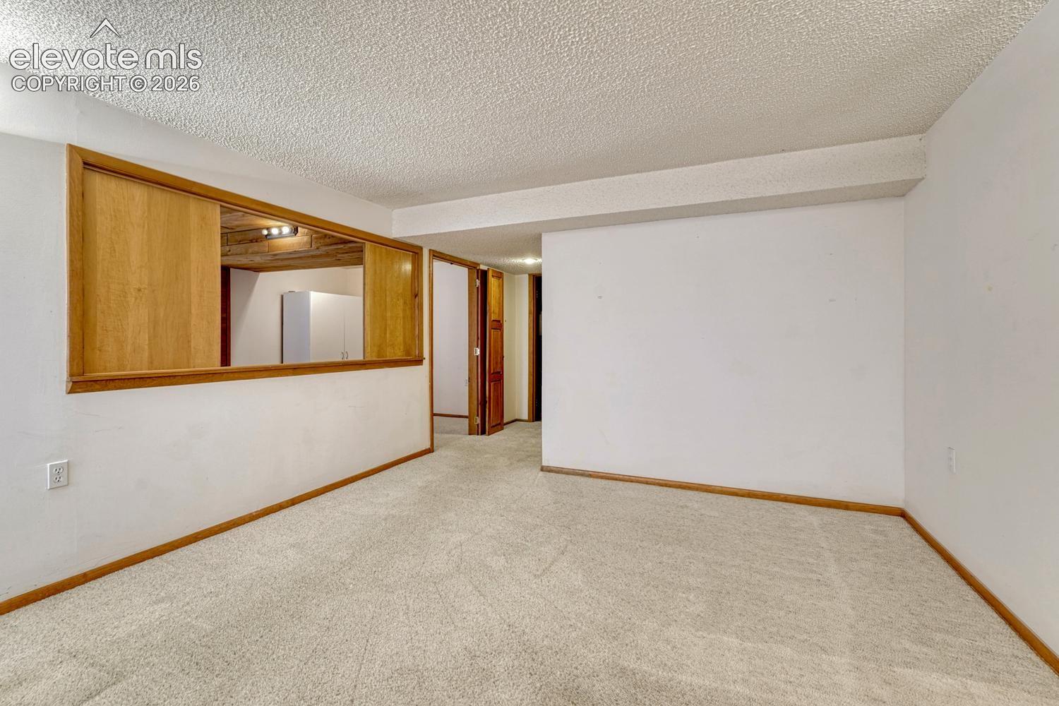 Basement family room with pass through into the basement bedroom and entire basement and stairs have new carpet now.
