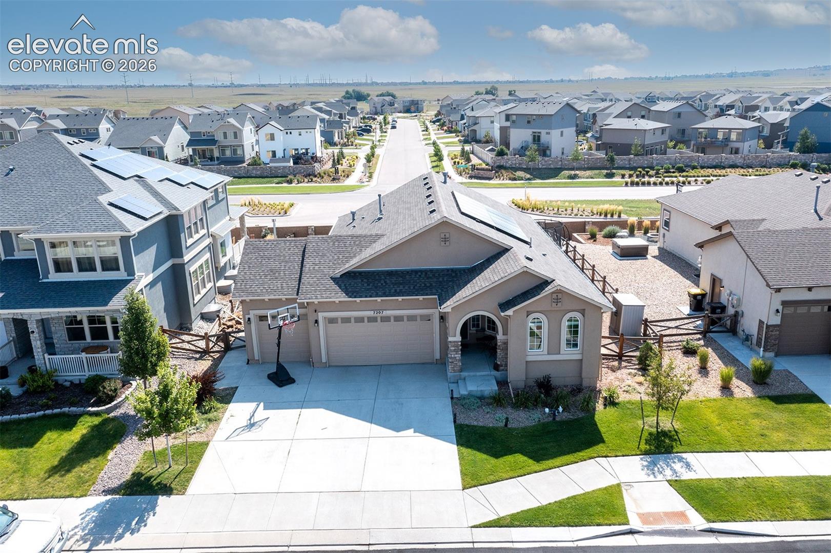 Stucco exterior with stone accents, attached two-car garage, and a concrete driveway